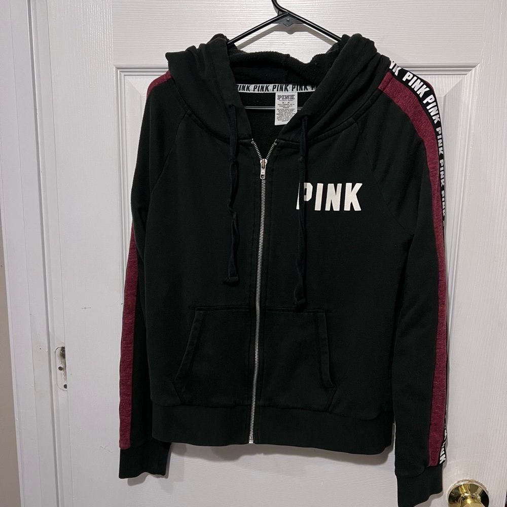 Pink hooded zip sweatshirt. Black white and maroon. Logo down both sleev…